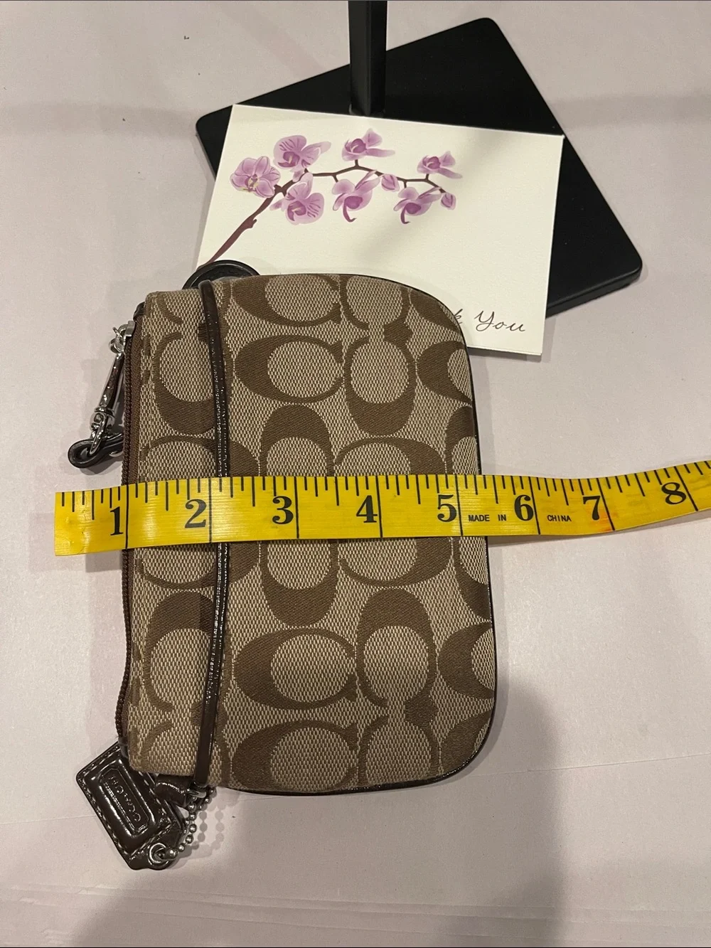 Coach Signature Small Wristlet in a khaki zipped coin purse